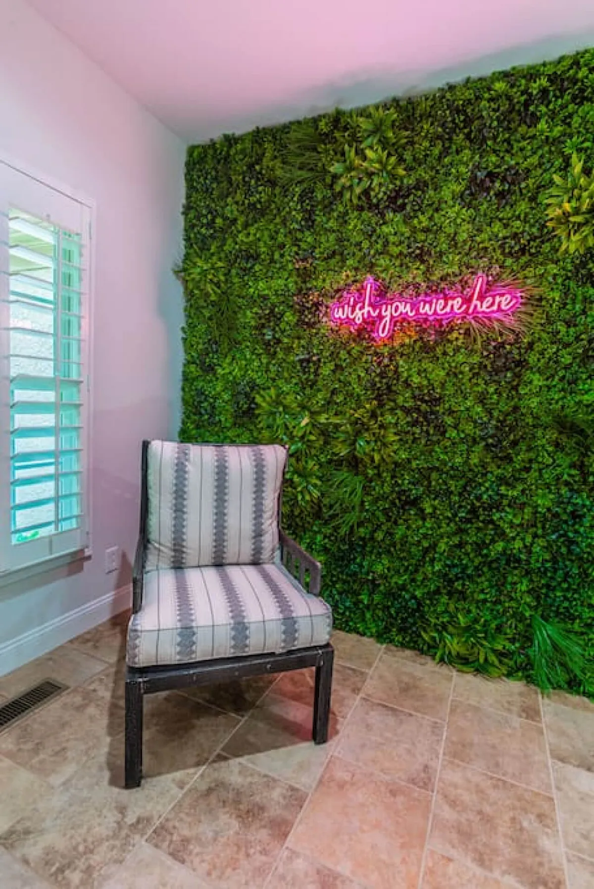 Featuring a trendy neon sign on a vibrant green wall with a comfortable chair, this interior spot is designed for guests to relax, take photos, and socialize. The selfie wall is an Instagram-worthy backdrop that captures the fun, celebratory spirit of the property.